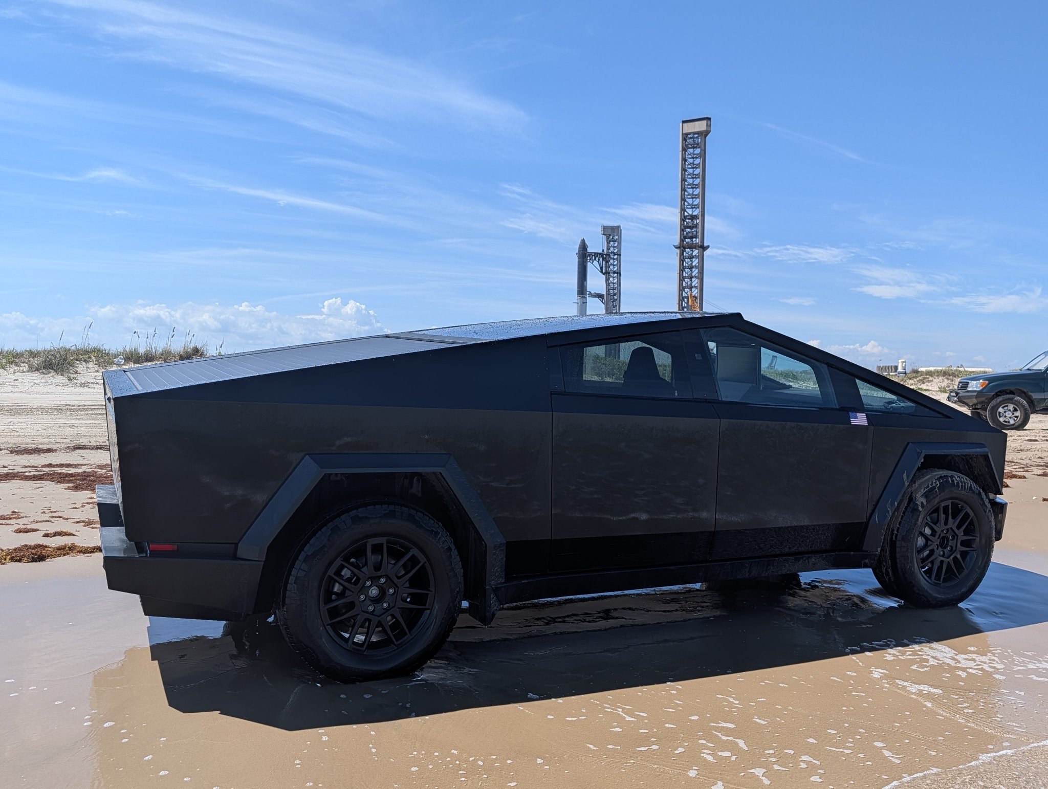 The Beast on Boca Chica Beach with the Starship Flight 14 stack behind it